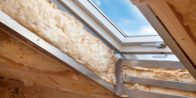 skylight window in attic roof showing insulation, before finishing touches skylight window in attic roof showing insulation, before finishing touches