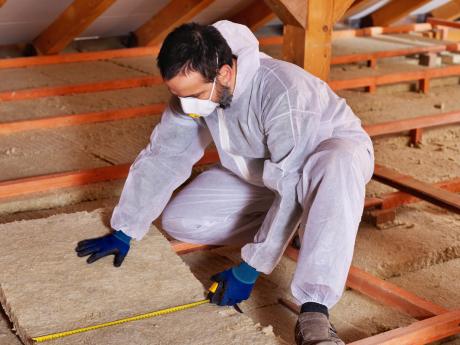 Contractor Measuring and Installing Insulation