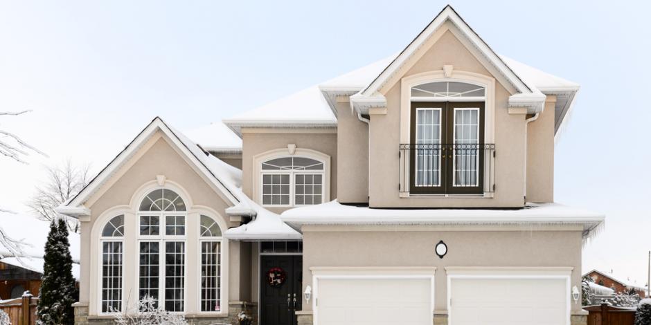 two story house covered in snow