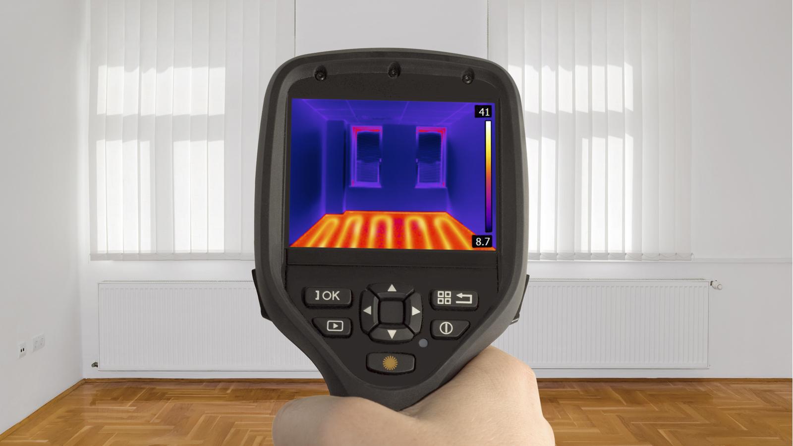 Infrared Camera Being Used in an Energy Audit Infrared Camera in Home